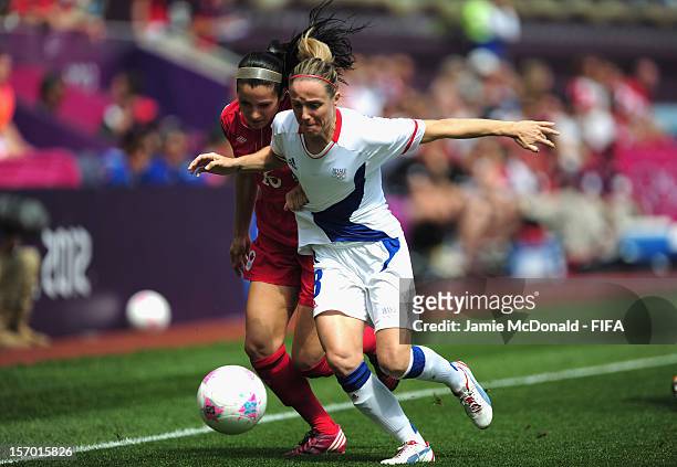 Jonelle Filigno of Canada battles with Sonia Bompastor of France during the Women's Football Bronze Medal match between Canada and France, on Day 13...
