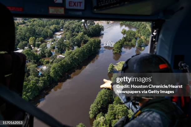 Sgt. Destry Riggs scans flooded areas during a search and rescue operation run by the 36th Combat Aviation Brigade of the Texas Army national Guard...