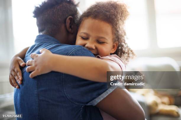 father and daughter embracing at home - family reunion stock pictures, royalty-free photos & images