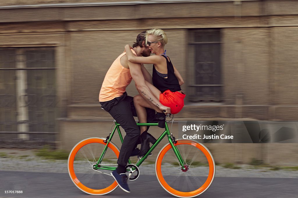 A couple biking through the city