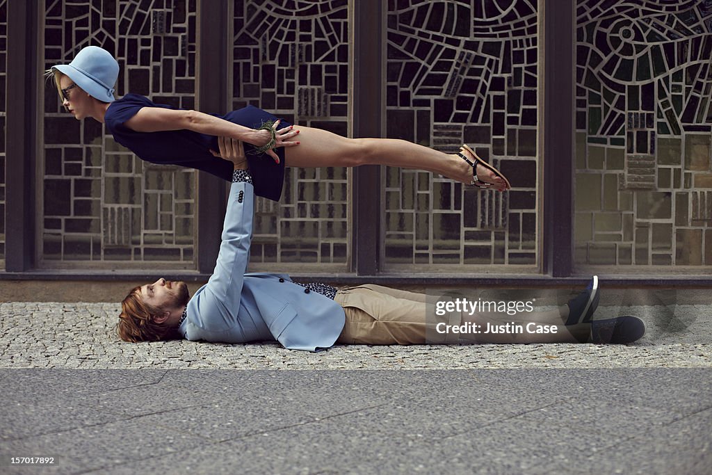 A couple on the floor man lifting woman up