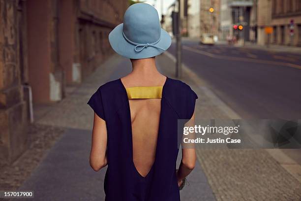 a young woman walking through the city - fashion millinery woman stock-fotos und bilder