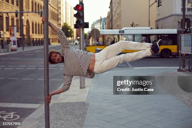 a man doing a tricky parkour move - silly fun stock pictures, royalty-free photos & images