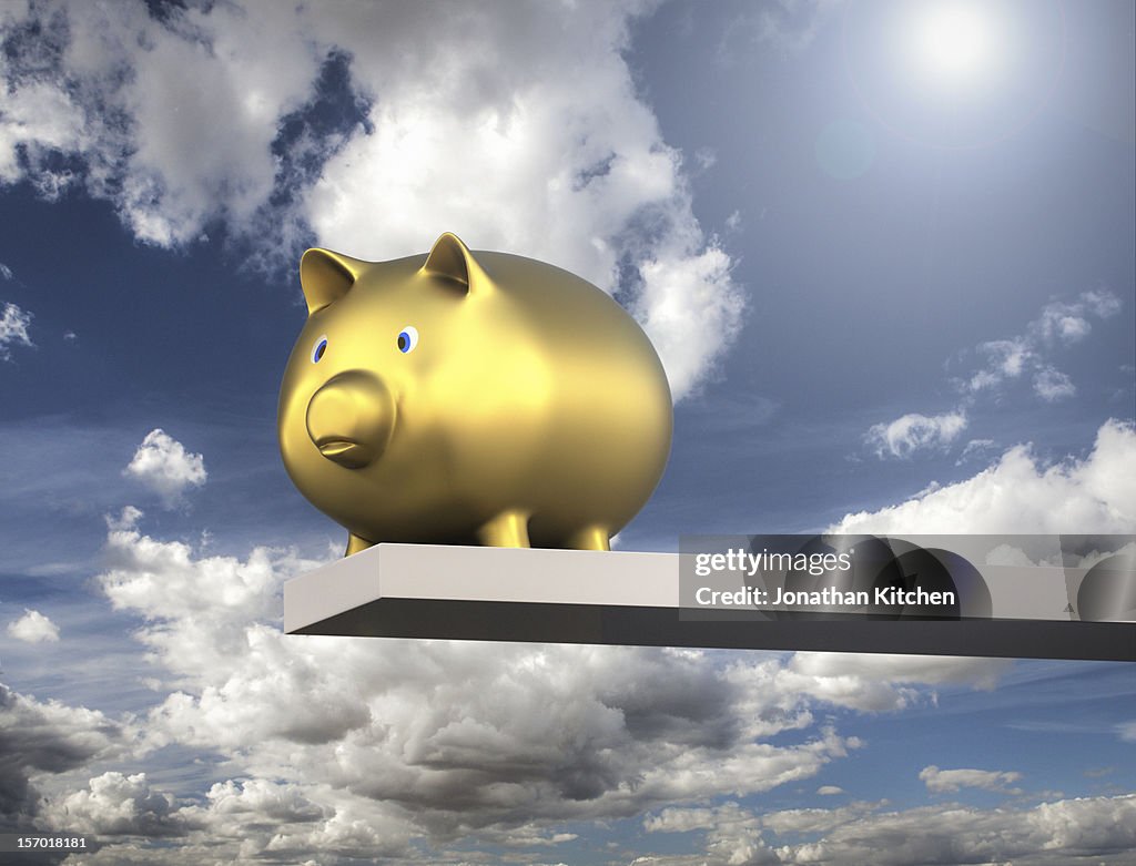 Golden Piggy Bank against sky