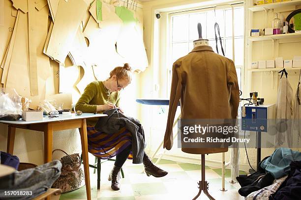 Woman sewing in clothing manufacturer's workshop