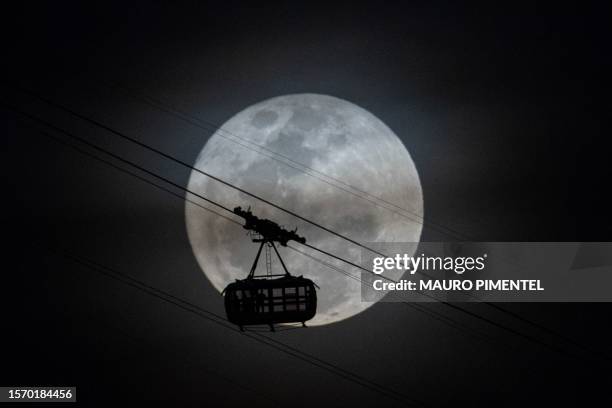 The second supermoon of 2023, also known as the Sturgeon Moon, rises behind the cable car of the Sugar Loaf mountain in Rio de Janeiro, Brazil, on...