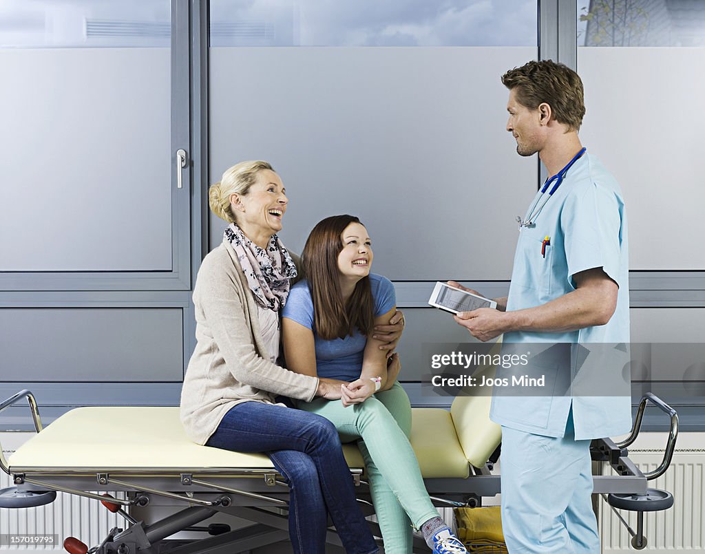 Surgeon talking to mother and daughter