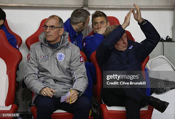 Queens Park Rangers manager Harry Redknapp applauds his new supporters as Joe Jordan sits next to him during the Barclays Premier League match...