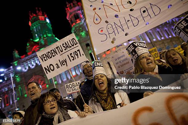 Woman shouts and holds a placard that reads 'Sell your health,' amid other health workers during a demonstration held on the second day of a two-day...