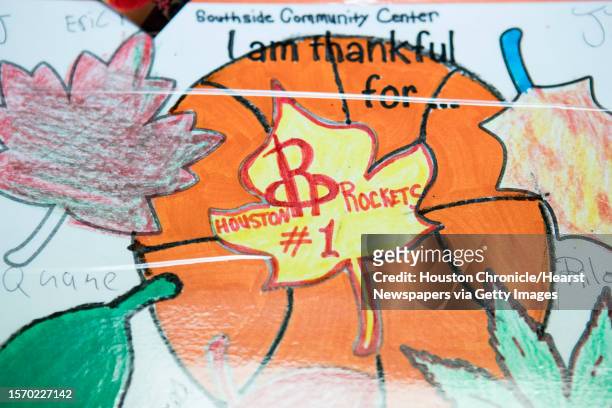 Thank you" placemat is shown during a Thanksgiving meal served by the Houston Rockets coaches for families from Homeade Hope at Corder Place...