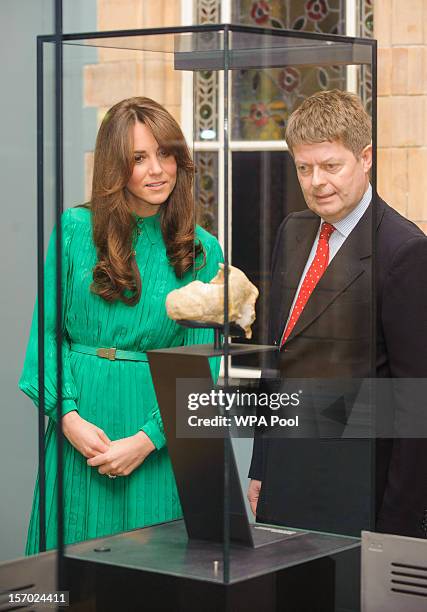Catherine, Duchess of Cambridge views an exhibit alongside Director of the Natural History Museum Doctor Michael Dixon as she attends the official...