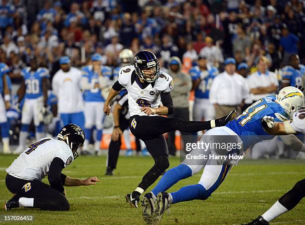 Justin Tucker of the Baltimore Ravens kicks a game winning field goal by Corey Lynch of the San Diego Chargers for a 16-13 win in overtime at...