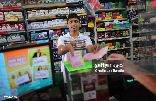 Nitesh Phel sells Powerball tickets at Circle News Stand on November 27, 2012 in Hollywood, Florida. The jackpot for Wednesday's Powerball drawing is...