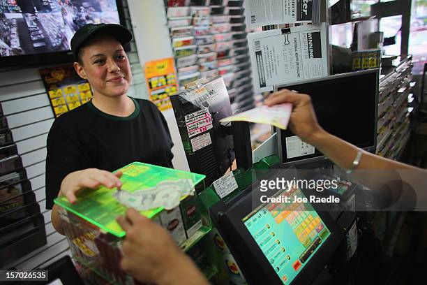 Stefanie Graef buys Powerball tickets at Circle News Stand on November 27, 2012 in Hollywood, Florida. The jackpot for Wednesday's Powerball drawing...