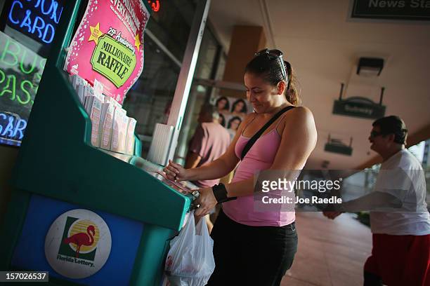 Vanessa Lopez fills out her Powerball numbers as she buys tickets at Circle News Stand on November 27, 2012 in Hollywood, Florida. The jackpot for...
