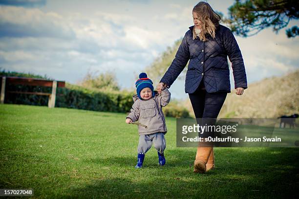 walking with mum in the park - s0ulsurfing stock pictures, royalty-free photos & images