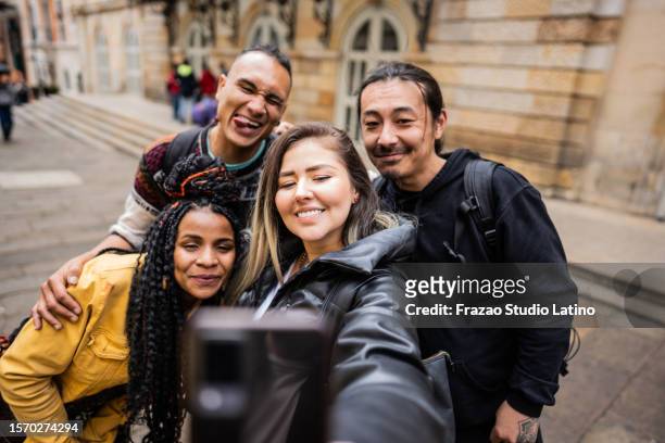 friends taking a selfie in historic district in bogota, colombia - la candelaria bogota stock pictures, royalty-free photos & images