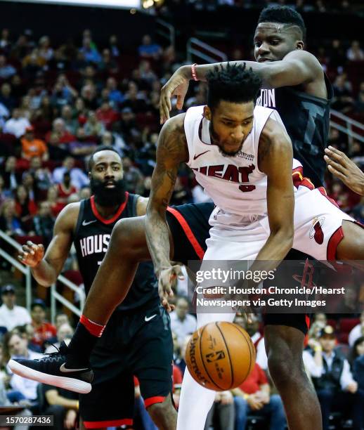 Miami Heat forward Derrick Jones Jr. And Houston Rockets center Clint Capela go after a rebound during the fourth quarter of an NBA basketball game...