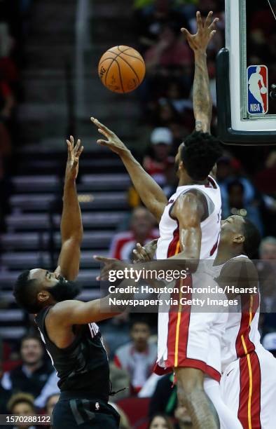 Houston Rockets guard James Harden takes a shot with Miami Heat forward Derrick Jones Jr. During the third quarter of an NBA basketball game at...