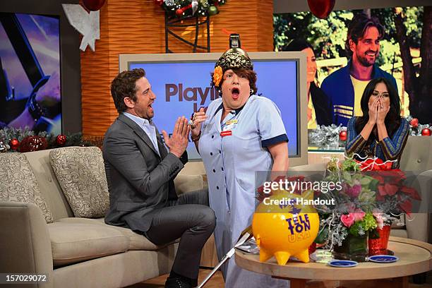 In this handout image provided by Univision, DA personality Dona Meche is surprised by Gerard Butler on the set of "Despierta America" November 27,...