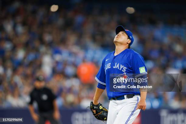 Hyun Jin Ryu of the Toronto Blue Jays watches a hit fly over his head in the first inning of their MLB game against the Baltimore Orioles at Rogers...