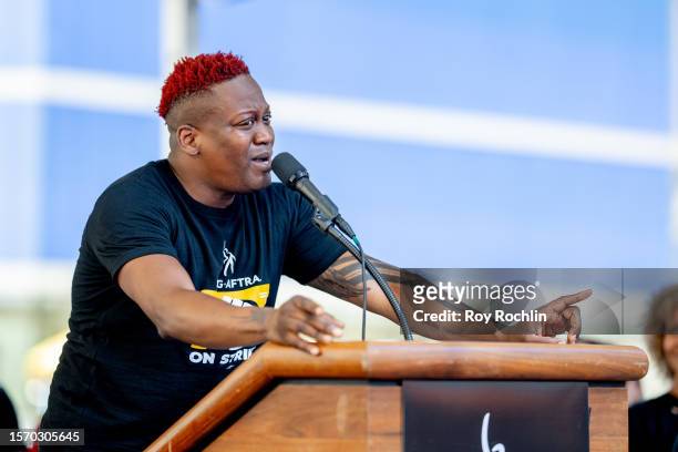 Titus Burgess sings as SAG-AFTRA members hold "Rock The City For A Fair Contract" rally in Times Square on July 25, 2023 in New York City. Members of...