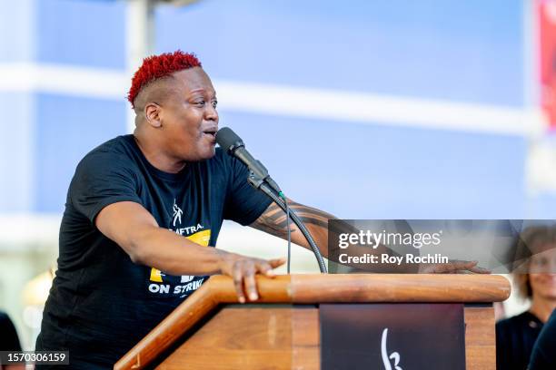 Titus Burgess sings as SAG-AFTRA members hold "Rock The City For A Fair Contract" rally in Times Square on July 25, 2023 in New York City. Members of...