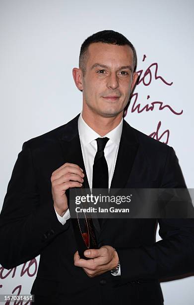 Jonathan Saunders , winner of the Emerging Talent - Menswear award poses in the awards room at the British Fashion Awards 2012 at The Savoy Hotel on...