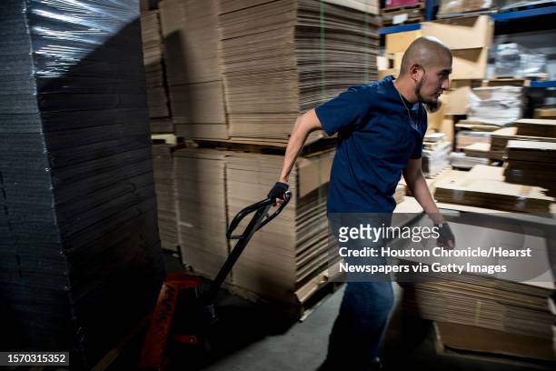 Gorge Martinez moves a palate of foam packing supplies in the warehouse at American Packging and Supply, Inc., on Thursday, Feb. 1 in El Paso, Texas.