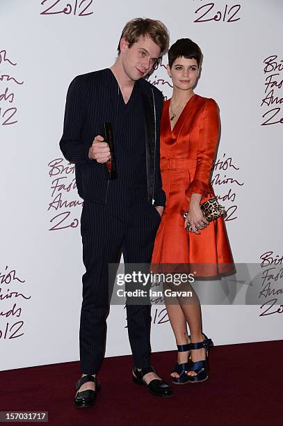 Jonathan Anderson of JW Anderson, winner of the Emerging Talent award, Ready-To-Wear, poses with presenter Pixie Geldof at the British Fashion Awards...