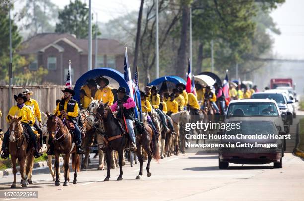 The Prairie View Trailriders Association ride along Pinemont as they make their way toward Memorial Park to on Friday, Feb. 23 in Houston.