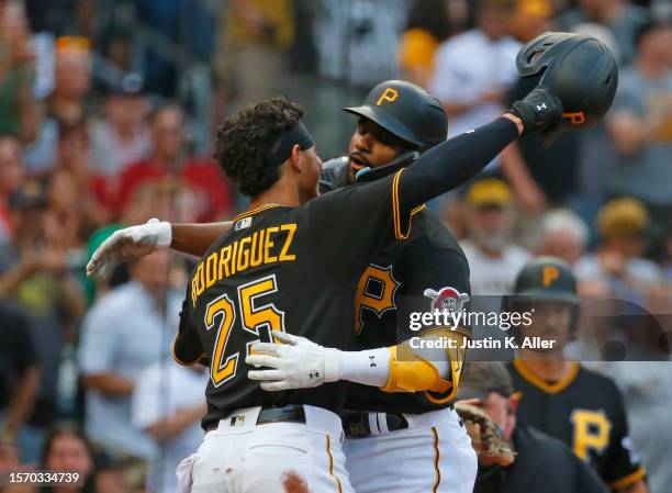 Liover Peguero of the Pittsburgh Pirates celebrates with Endy Rodriguez after hitting a two run home run in the second inning against the Detroit...