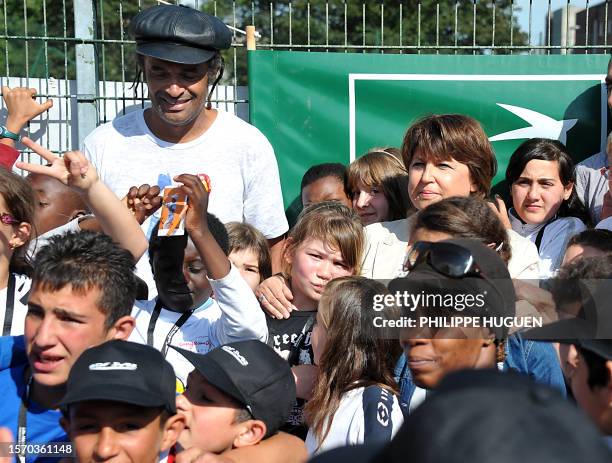 French leader of the Socialist Party and mayor of Lille, Martine Aubry poses with children in a Sensitive urban zone of the French northern city of...