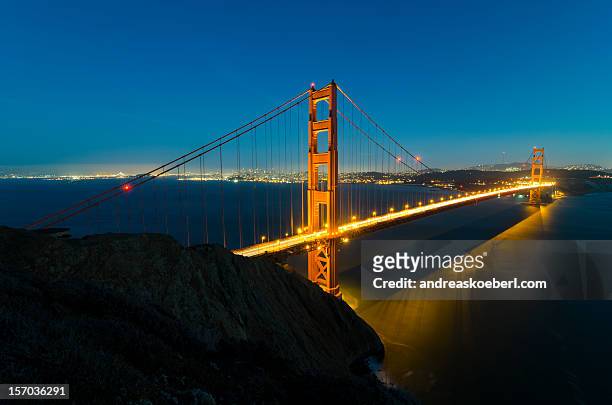 illuminated golden gate bridge - andreaskoeberl stock-fotos und bilder