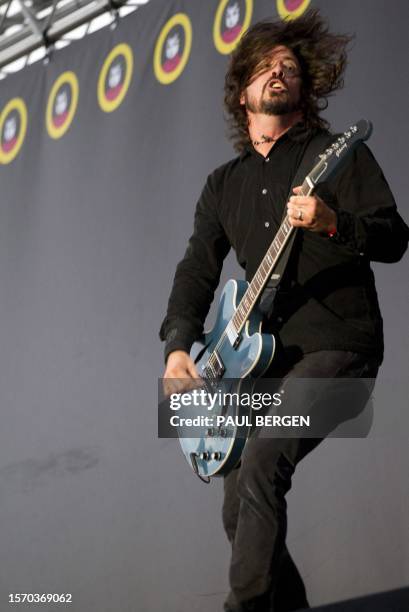 Singer Dave Grohl of the band Foo Fighters plays guitar during a performance at the Pinkpop festival in Landgraaf, on June 13, 2011. AFP PHOTO / ANP...