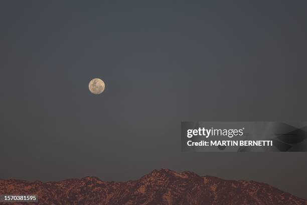 The second supermoon of 2023, also known as the Sturgeon Moon, rises over the Andes in Santiago on August 1, 2023. Algonquian native American tribes...