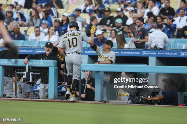 Bryan Reynolds of the Pittsburgh Pirates celebrates with teammates after hitting a solo home run against the Los Angeles Dodgers during the first...