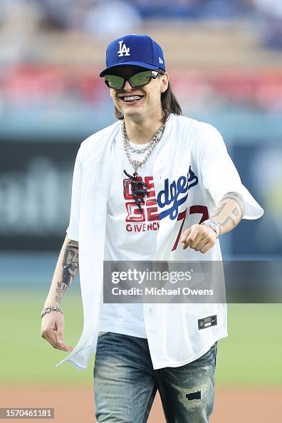 Peluma Rapper Rapper Peso Pluma reacts after throwing the first pitch prior to a ...