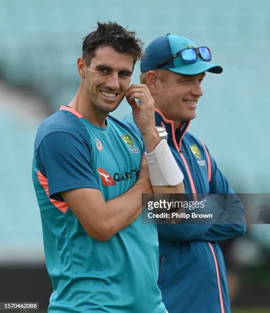 Pat Cummins and Andrew McDonald of Australia look on during a training session before the 5th Test between England and Australia at The Kia Oval on...