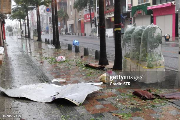 Scattered debris litters a downtown street as high winds brought by Typhoon Khanun hit the city of Naha, Okinawa prefecture on August 2, 2023....