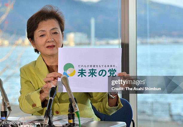 Shiga Prefecture governor Yukiko Kada, displays her new anti-nuclear party 'Nippon Mirai no To ' logo during a press conference on November 27, 2012...