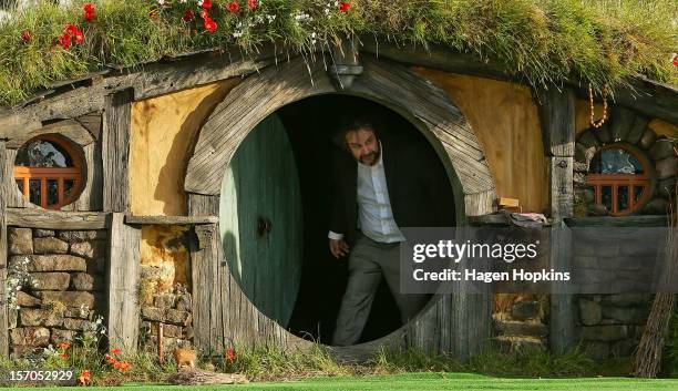 Director Sir Peter Jackson emerges from from a Hobbit house before delivering a speech at the "The Hobbit: An Unexpected Journey" World Premiere at...