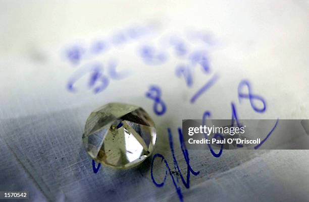 Diamond sits on its polishing instructions October 31, 2002 in Antwerp, Belgium. The gem traders in Antwerp are under pressure to regulate the sales...
