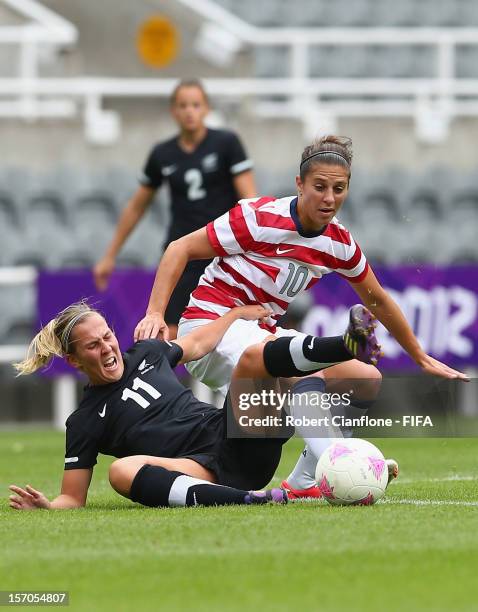 Kirsty Yallop of New Zealand is tackled by Carli Lloyd of the USA during the Women's Football Quarter Final match between United States and New...