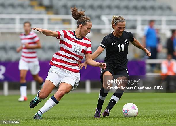 Kirsty Yallop of New Zealand is pressured by Lauren Cheney of the USA during the Women's Football Quarter Final match between United States and New...