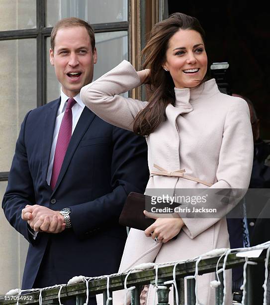 Catherine, Duchess of Cambridge and Prince William, Duke of Cambridge smile and wave to the crowds from the balcony of Cambridge Guildhall as they...
