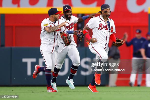 Eddie Rosario, Michael Harris II and Ronald Acuna Jr. #13 of the Atlanta Braves react following the 5-1 victory over the Los Angeles Angels at Truist...