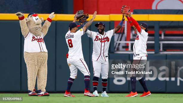 Eddie Rosario, Michael Harris II and Ronald Acuna Jr. #13 of the Atlanta Braves react following the 5-1 victory over the Los Angeles Angels at Truist...