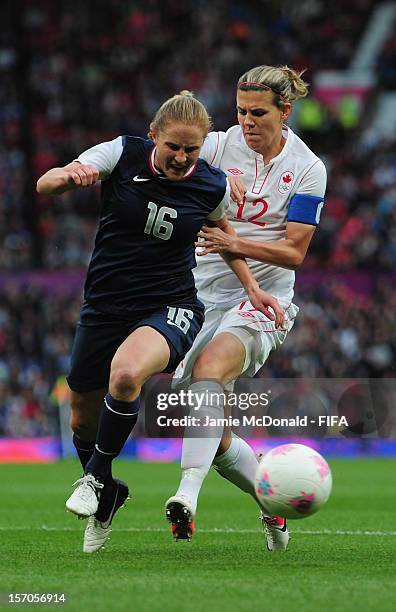 Christine Sinclaire of Canada battles with Rachel Buehler of USA during the Women's Football Semi Final match between Canada and USA, on Day 10 of...