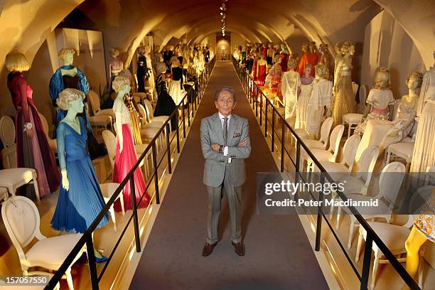 Fashion designer Valentino Garavani poses beside exhibits during a press preview of the 'Valentino: Master of Couture' exhibition at Somerset House...